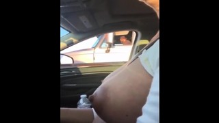 Woman shows her tits while driving and squeezes her nipples